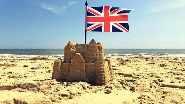 Sand castle at the beach with Union Jack 